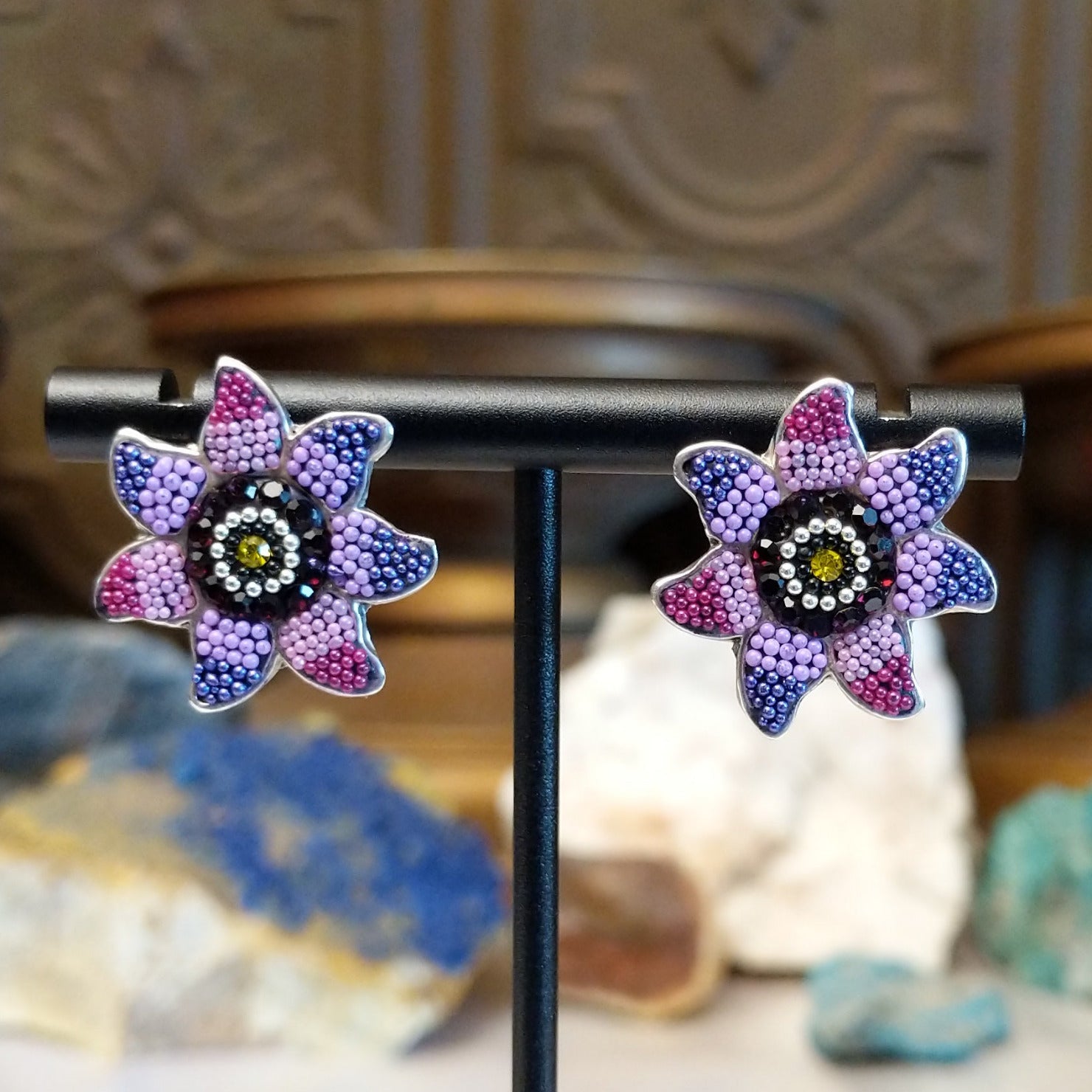 Sterling silver sun earrings with rainbow colored Austrian crystal.