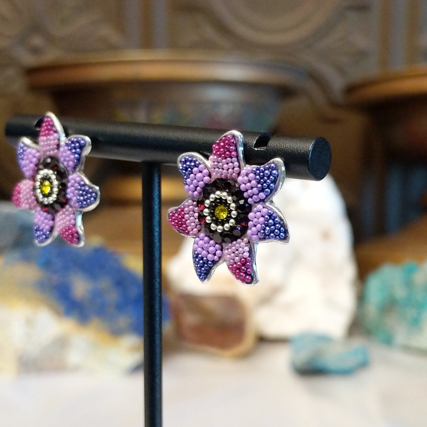 Sterling silver sun earrings with rainbow colored Austrian crystal.