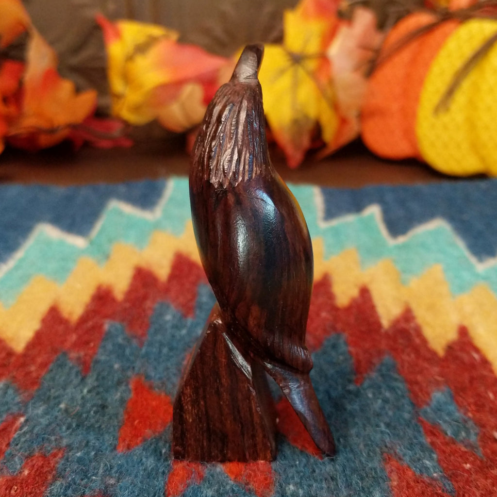 Ironwood carved into a detailed quail figurine.