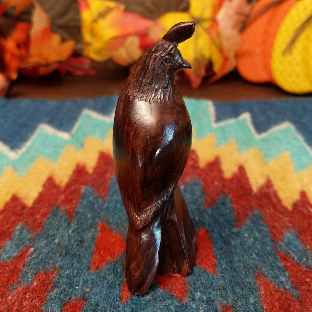 Ironwood carved into a detailed quail figurine.