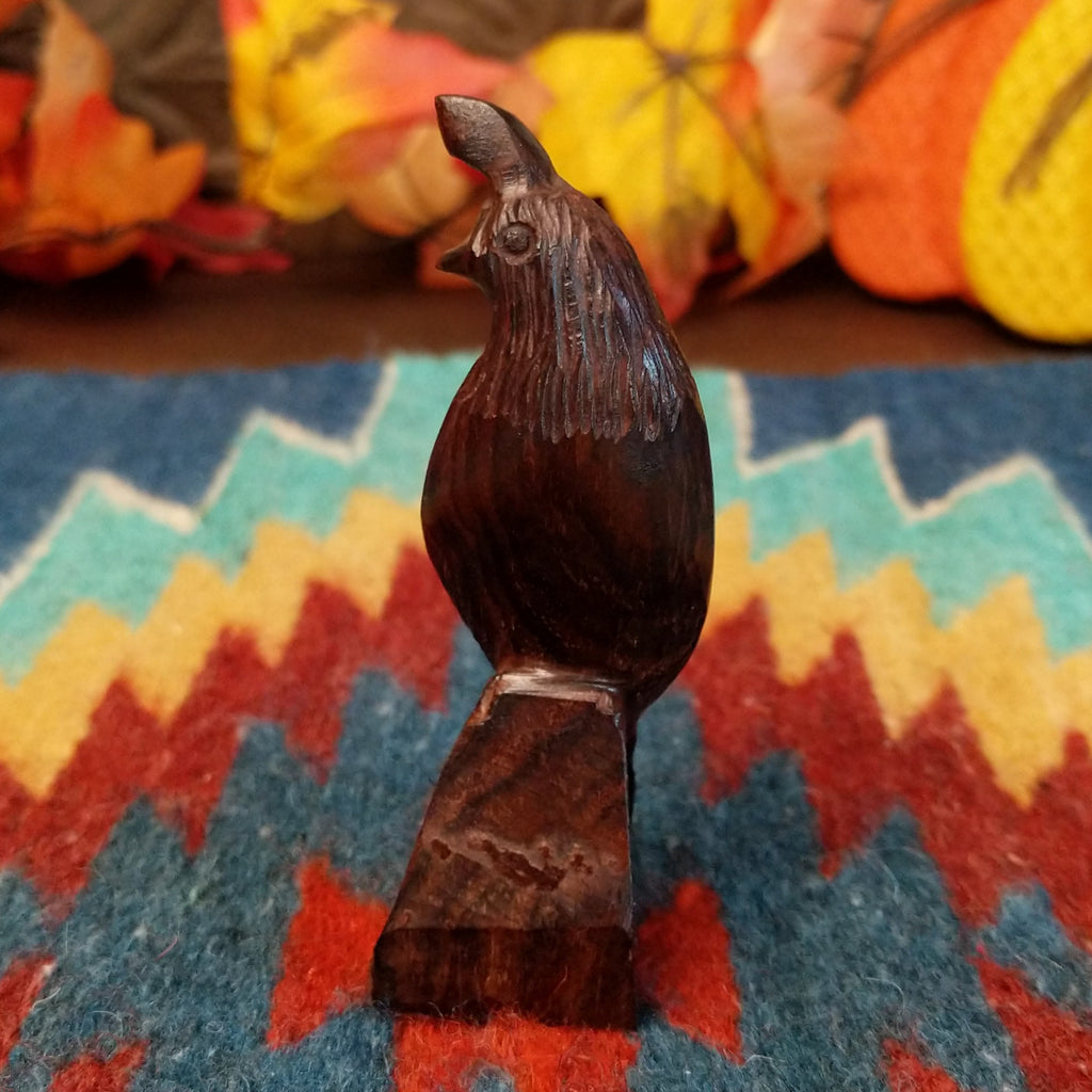 Ironwood carved into a detailed quail figurine.
