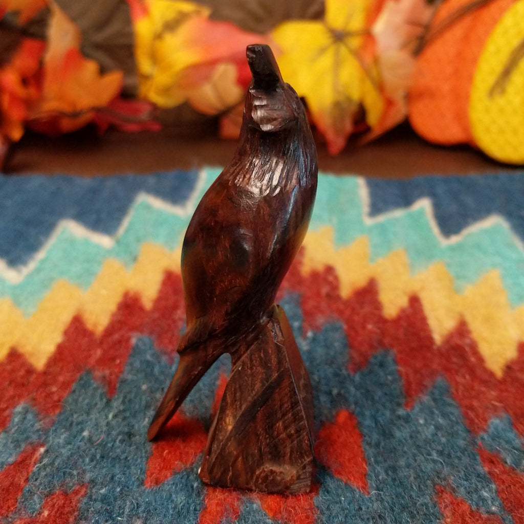 Ironwood carved into a detailed quail figurine.