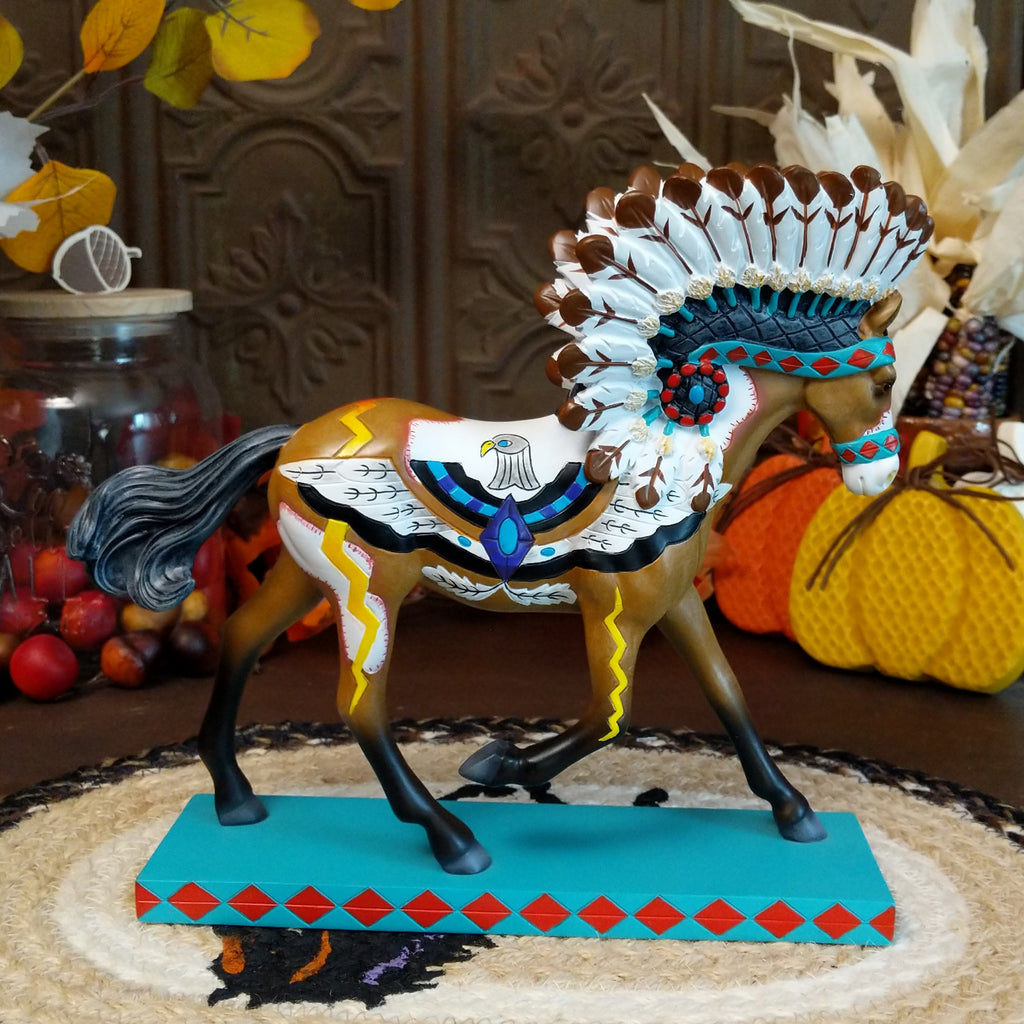 Resin pony painted brown and white with Native American motifs and a traditional headdress.