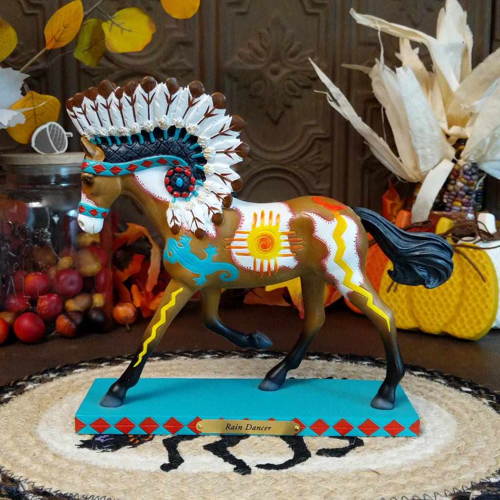 Resin pony painted brown and white with Native American motifs and a traditional headdress.