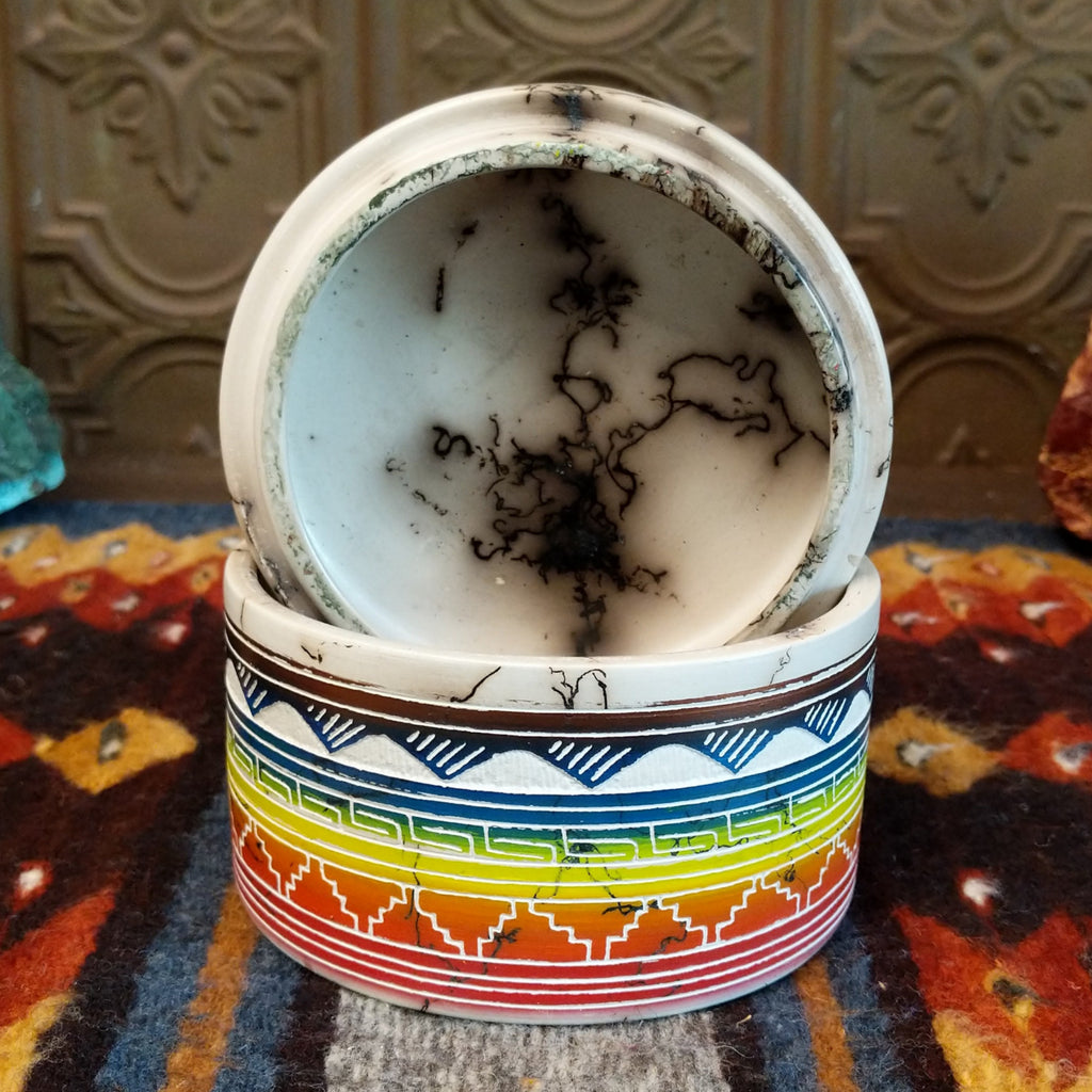 Rainbow Buffalo jar displaying rainbow layers and horsehair texture on white clay and inside of the lid.