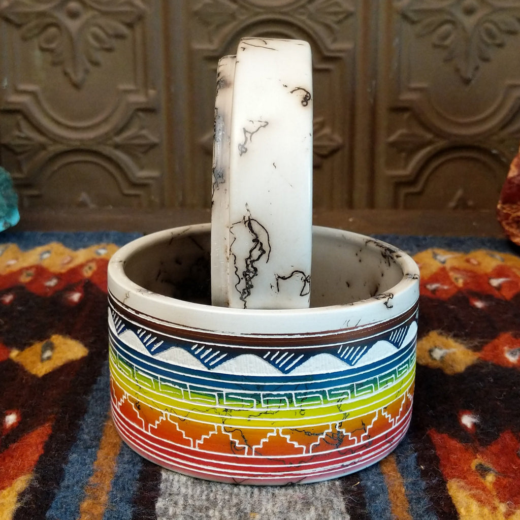 Rainbow Buffalo jar displaying rainbow layers and horsehair texture on white clay.