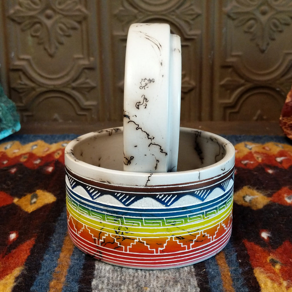 Rainbow Buffalo jar displaying rainbow layers and horsehair texture on white clay.
