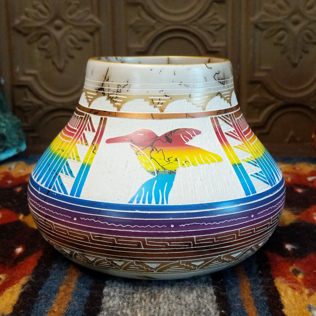 Rainbow Hummingbird horsehair pottery with white clay, vibrant rainbow stripes, and a hummingbird design.