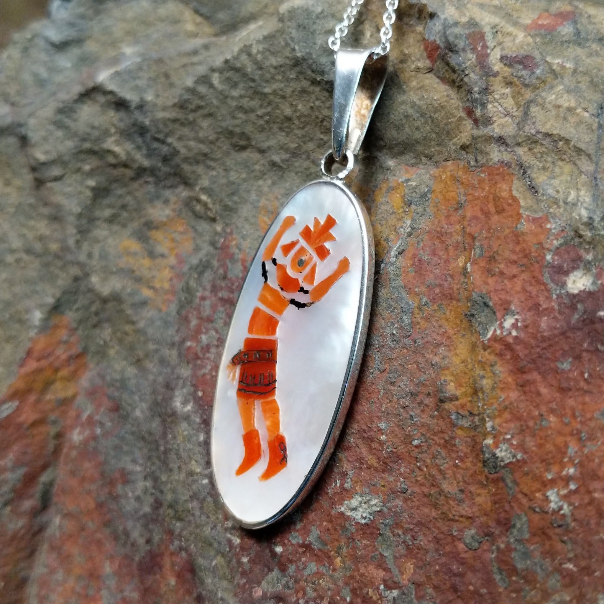 Handcrafted sterling silver Rainbow Kachina pendant by Harlan & Monica Coonsis, featuring vibrant Zuni multistone inlay; side view.