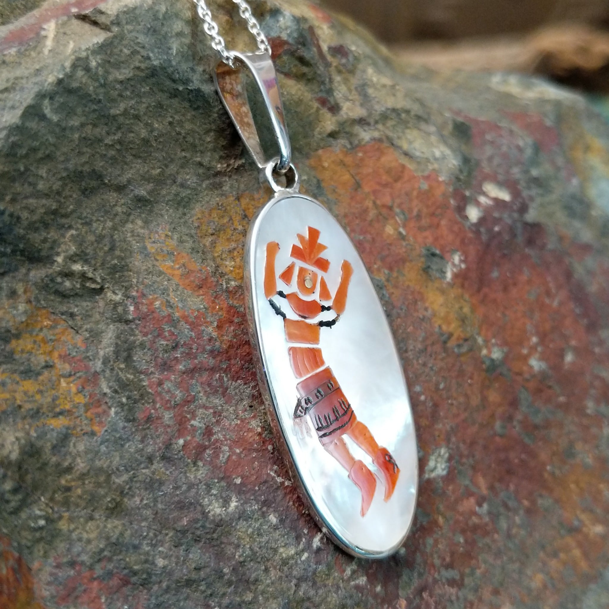 Handcrafted sterling silver Rainbow Kachina pendant by Harlan & Monica Coonsis, featuring vibrant Zuni multistone inlay; side view.
