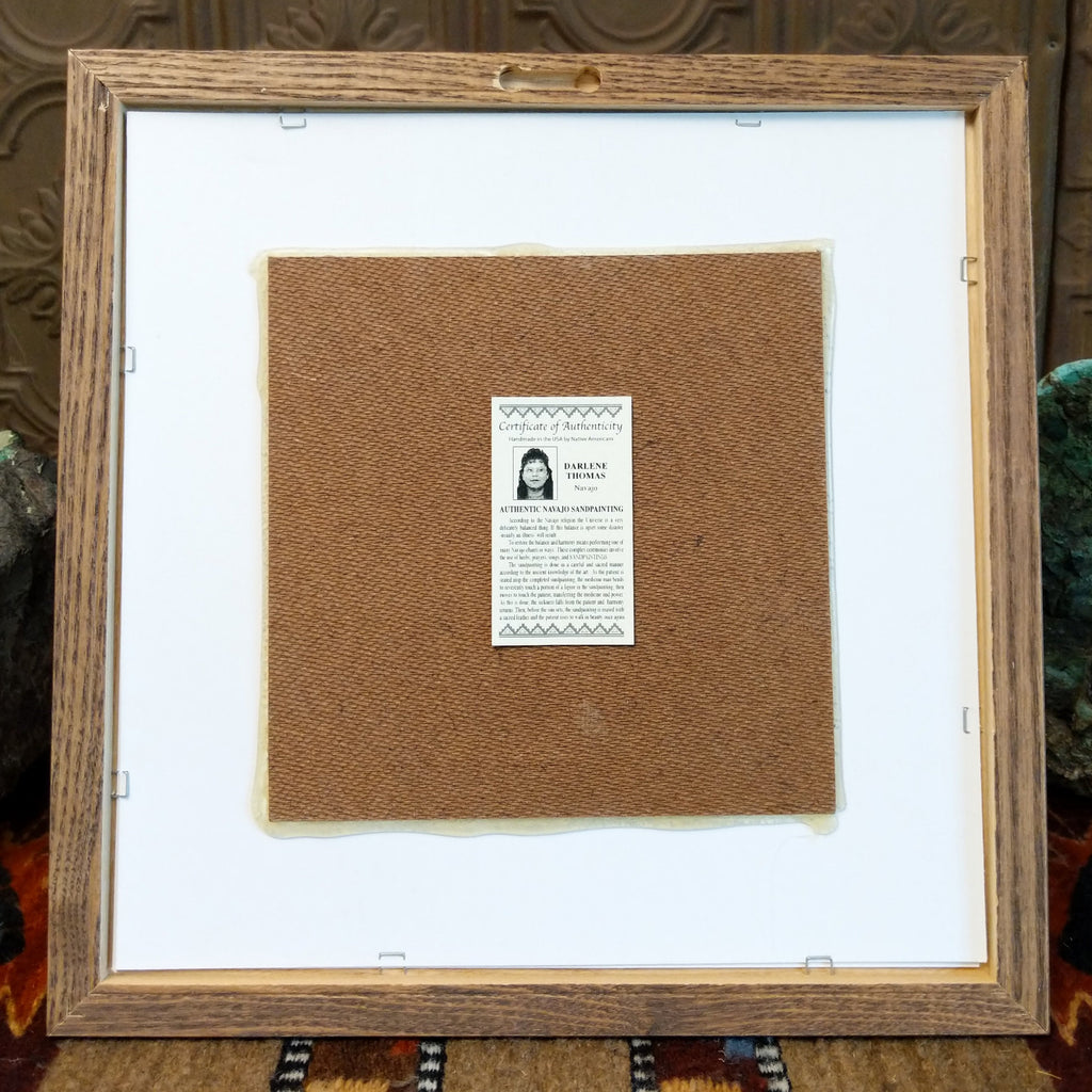The back features a hook to hang the painting and the artisan's authentication tag.