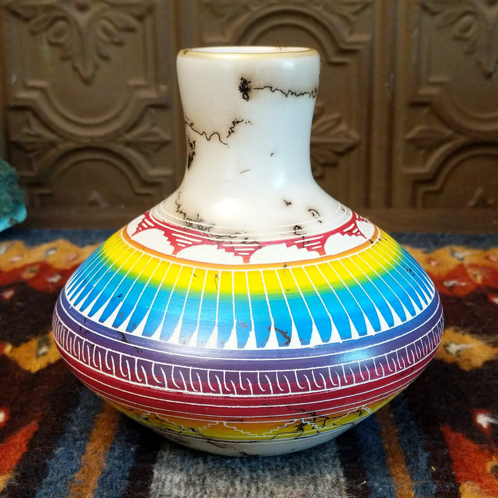 Vase showcasing rainbow layers and horsehair texture on white clay.
