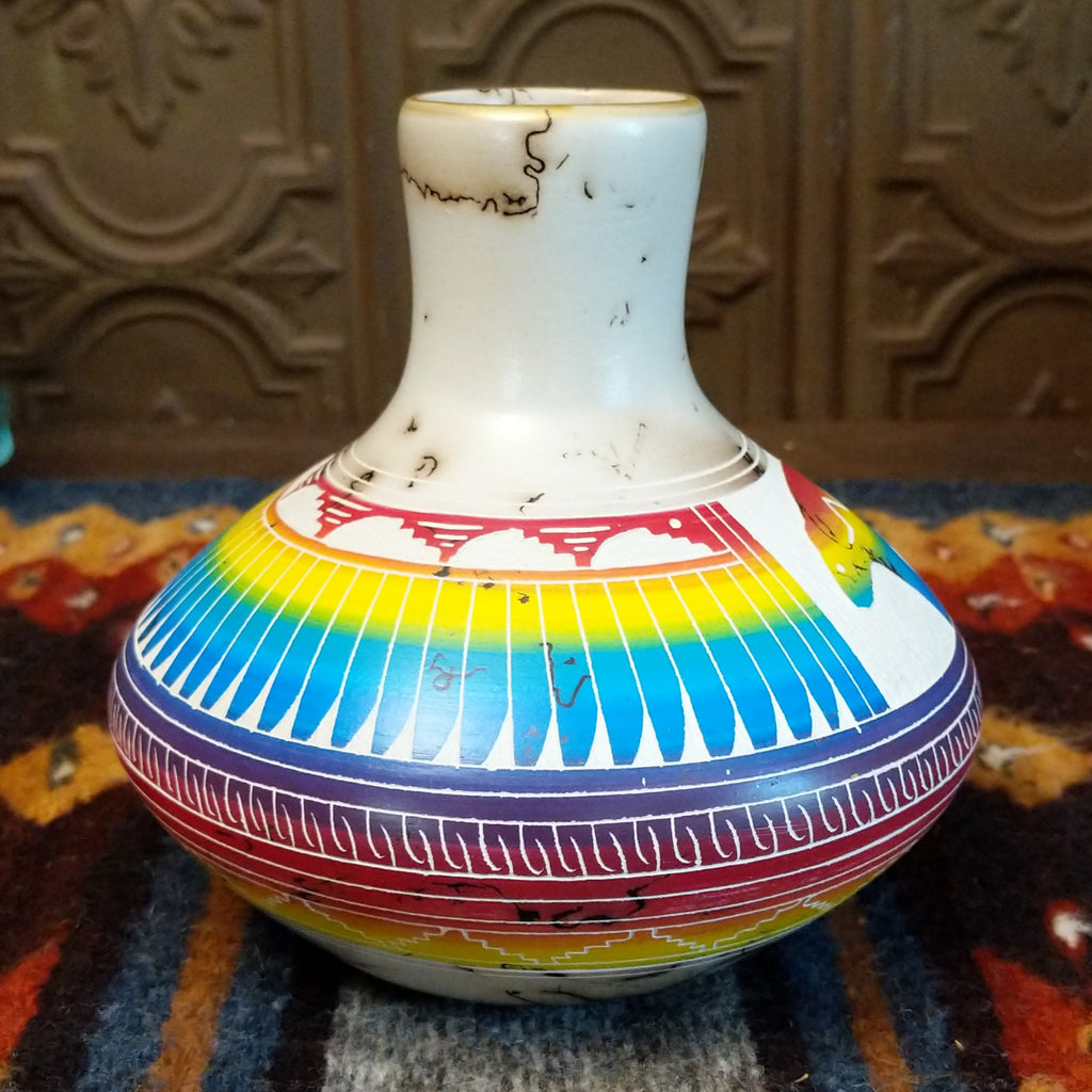 Vase showcasing rainbow layers and horsehair texture on white clay.