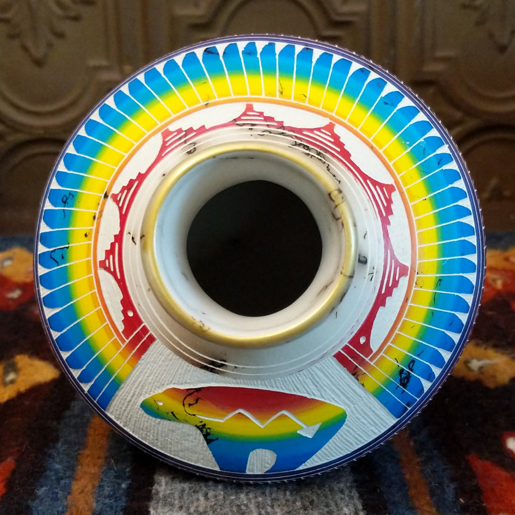 Interior of rainbow pottery revealing smooth white clay surface.