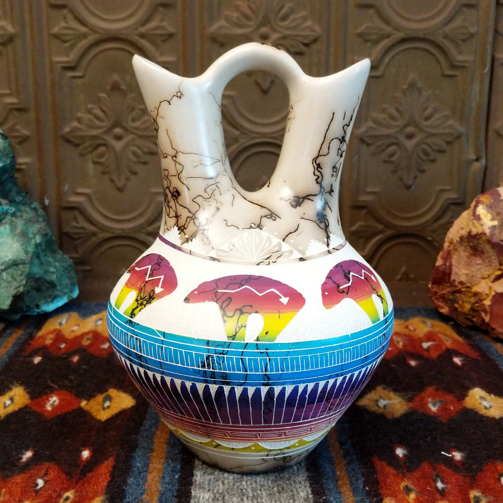 Wedding vase with white clay, rainbow stripes, and spirit bear designs all along the vase.