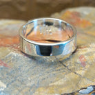 Sterling silver ring with lapis inlaid on the raised bezel and geometric designs on the band.