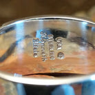 Close-up of the artisan's stamped signature.