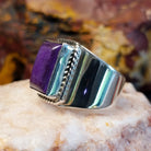 Sterling silver ring with sugilite set in a raised bezel with twisted rope accents, and a polished finish.