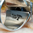 Close-up of the artisan's stamped signature.