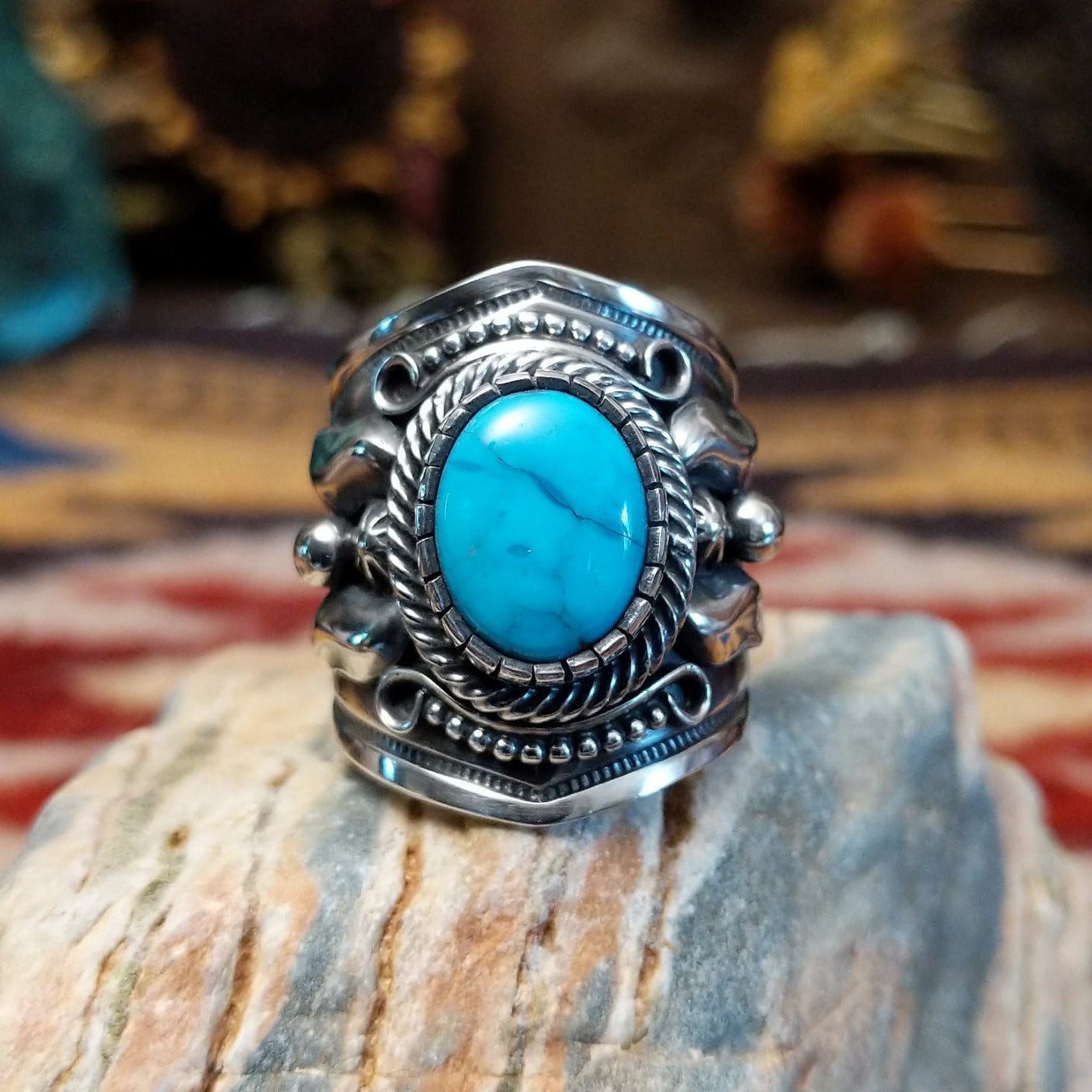 Handcrafted Navajo sterling silver ring by Murphy Platero featuring a raised oval turquoise stone surrounded by twisted wire, beadwork, and traditional Southwestern silver detailing.