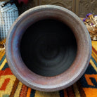 Round raku pottery vase by Roger Calhoun with a flared rim, raised geometric bands, and a metallic copper, bronze, and smoky brown finish.