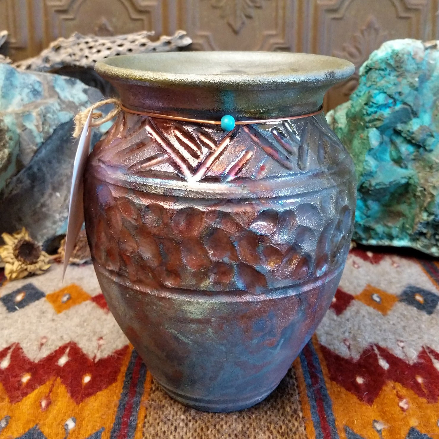 Raku pottery with geometric designs and oxidized copper appearance.