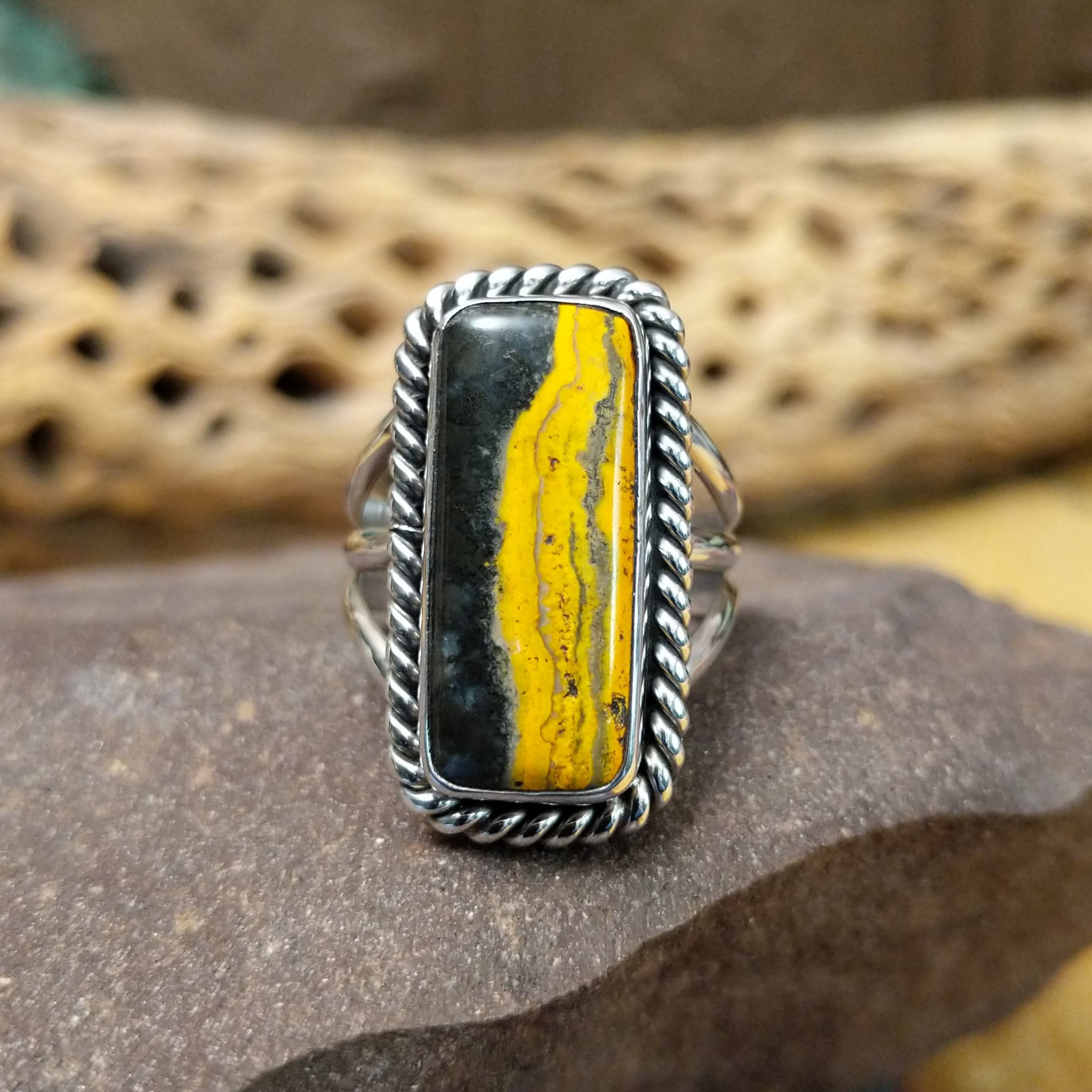 Rectangle bumblebee jasper ring by Terry Wood, featuring a vibrant rectangular bumblebee jasper stone with natural yellow, orange, black, and gray patterns set in a handcrafted sterling silver band.