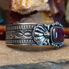 A rectangular purple spiny oyster shell cuff set in detailed sterling silver and ornate band.