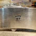 The interior of the cuff band shows the artist's signature stamped into it.