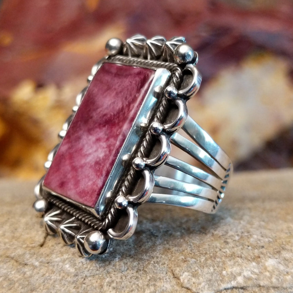 Rectangular purple spiny oyster shell framed by twisted rope, scalloped edges, dot work, and stars.