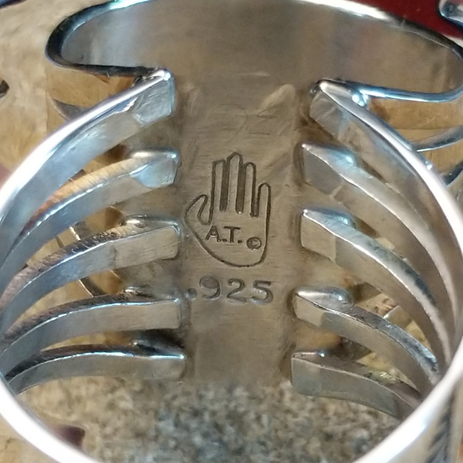 The artisan's initials are found on the underside of the bezel.