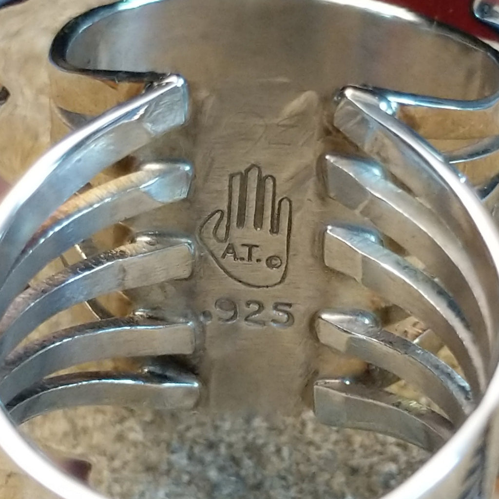 The artisan's initials are found on the underside of the bezel.