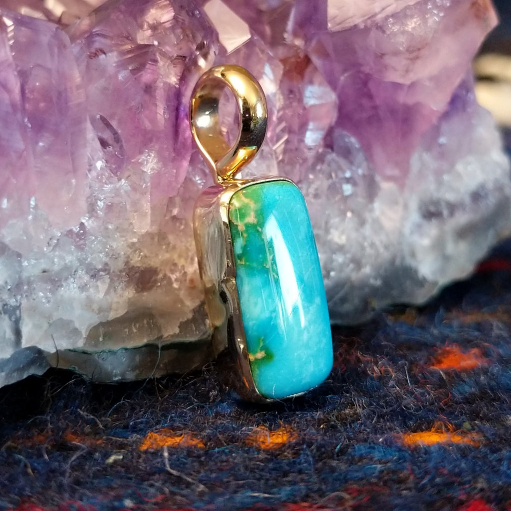 Rectangular Sonoran Gold turquoise set in a polished gold pendant.