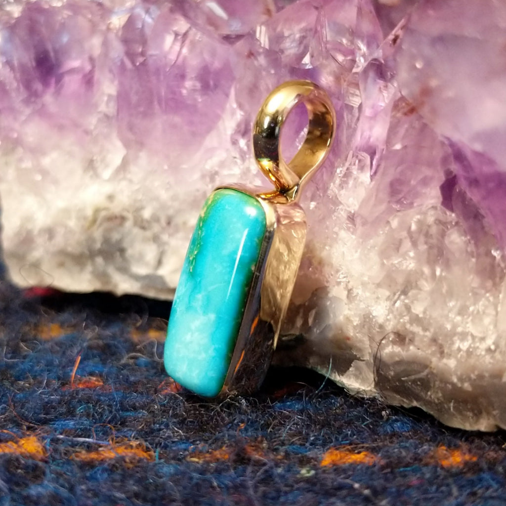 Rectangular Sonoran Gold turquoise set in a polished gold pendant.