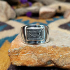 Sterling silver spiral ring by Raymond Coriz featuring a geometric stamped spiral design on a polished signet-style band with Southwestern craftsmanship.