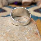 Sterling silver spiral ring by Raymond Coriz featuring a geometric stamped spiral design on a polished signet-style band with Southwestern craftsmanship; underside view.