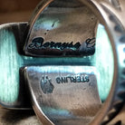 Close-up of the artisan's stamped signature.