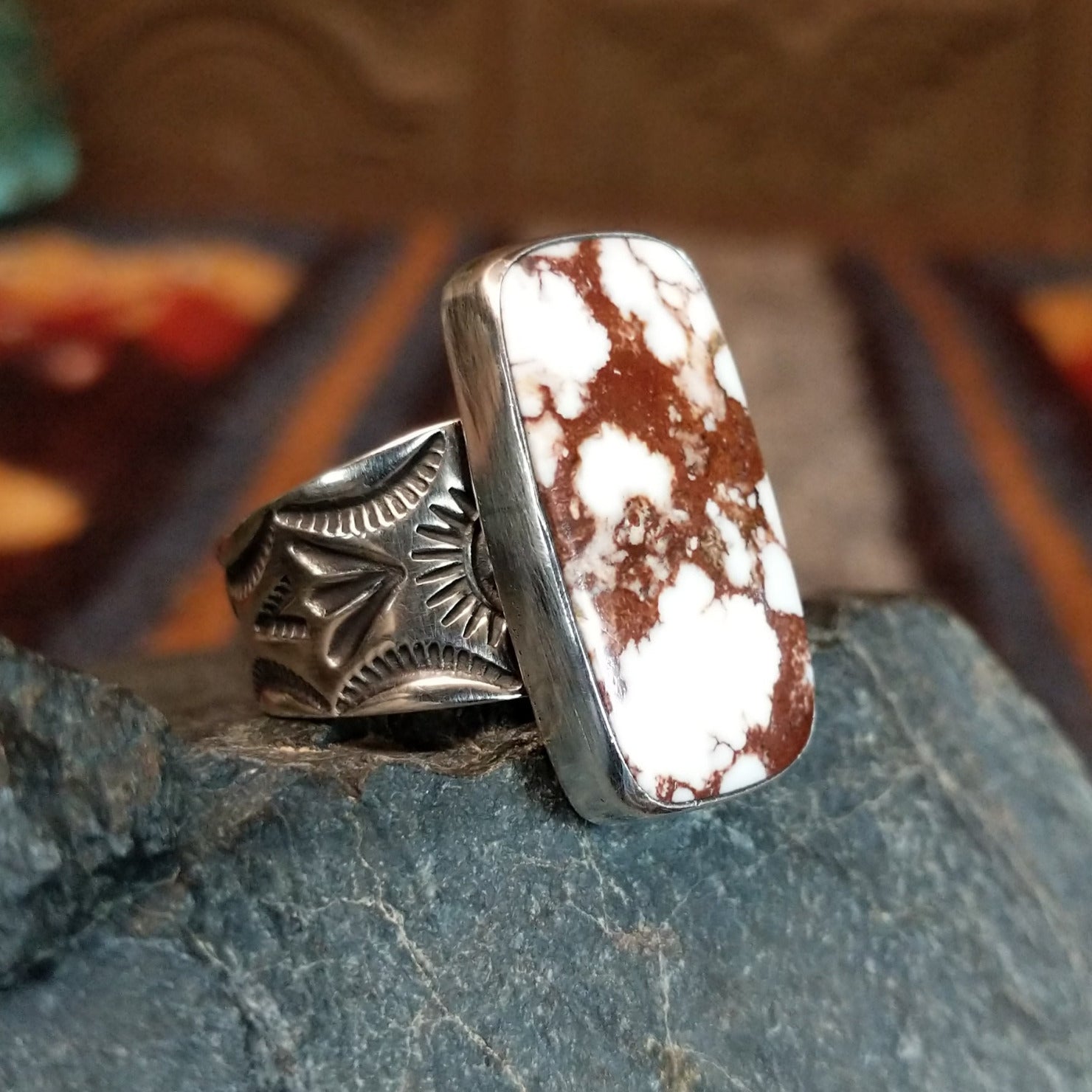 The side of the ring showcases the rectangular edge and stamped details on the band.