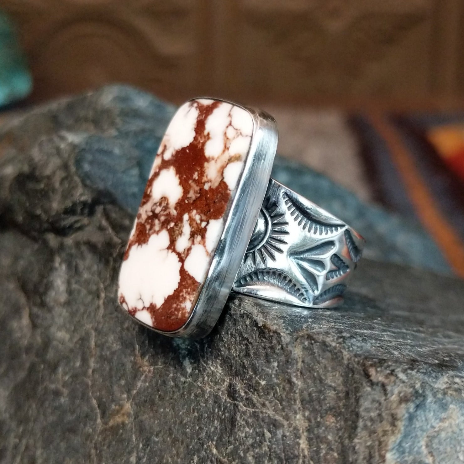 The side of the ring showcases the rectangular edge and stamped details on the band.
