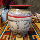Rounded horsehair pottery vase by Roger Calhoun with a wide red rim, multicolored crackled shoulder, red accent band, and black horsehair markings across a cream-colored body.