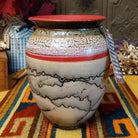 Rounded horsehair pottery vase by Roger Calhoun with a wide red rim, multicolored crackled shoulder, red accent band, and black horsehair markings across a cream-colored body.