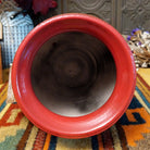 Rounded horsehair pottery vase by Roger Calhoun with a wide red rim, multicolored crackled shoulder, red accent band, and black horsehair markings across a cream-colored body.