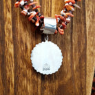 Backing of the sterling silver pendant featuring the artists stamp.