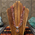 Features multi-strand red spiny oyster shell heishi beads with a sterling silver clasp and pendant.