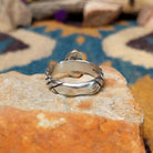 Sterling silver Red Spiny Oyster Shell ring by Raymond Coriz with a hand-stamped band and oval red gemstone; underside view.