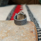Red spiny oyster shell ring by Akee Douglas with five-row twisted silver band.