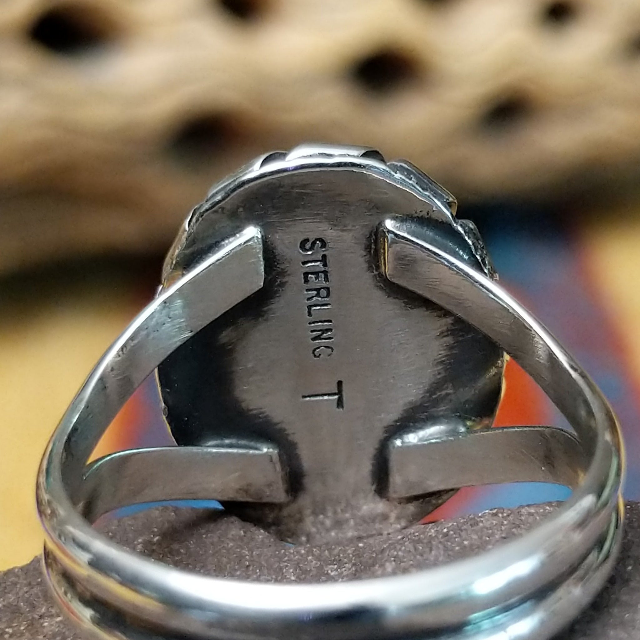Red spiny oyster shell ring by Terry Wood, featuring a vibrant red spiny oyster shell set in a handcrafted sterling silver band with traditional Southwestern-inspired metalwork.  Artisan and Sterling Silver stamp.
