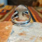 Redskin Turquoise Ring by Everett & Mary Teller featuring a large oval sky-blue turquoise stone with distinctive brown spiderweb matrix, a smooth polished surface, and a simple silver bezel setting; underside view.