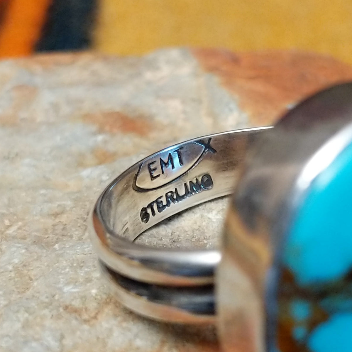 Redskin Turquoise Ring by Everett & Mary Teller featuring a large oval sky-blue turquoise stone with distinctive brown spiderweb matrix, a smooth polished surface, and a simple silver bezel setting; artisan and Sterling Silver stamp.