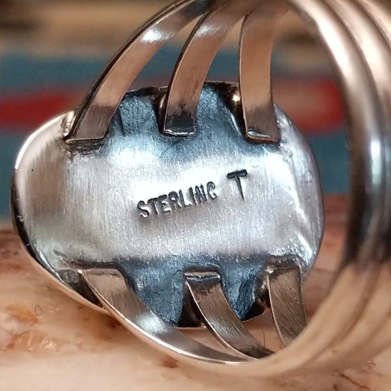 Close-up of the artist's stamped signature.